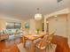Dining area showcases a wooden table with seating for six, complemented by stylish decor and ample lighting at 4238 Mackay Falls Ter, Sarasota, FL 34243