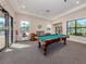 Brightly lit game room featuring a pool table, library, and comfortable seating at 4238 Mackay Falls Ter, Sarasota, FL 34243