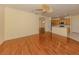 Spacious living room features wood floors and an open floor plan leading to the kitchen and dining area at 4238 Mackay Falls Ter, Sarasota, FL 34243