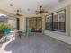 Covered patio with tile flooring, ceiling fans, and views of the backyard at 4238 Mackay Falls Ter, Sarasota, FL 34243