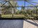 Large screened patio with pavers overlooking the lush backyard with mature trees and landscaping at 4238 Mackay Falls Ter, Sarasota, FL 34243