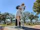 Statue of sailor kissing nurse with boats docked in a clear blue harbor in the background at 4238 Mackay Falls Ter, Sarasota, FL 34243