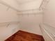Walk-in closet with hardwood floors and multiple rows of white wire shelving for maximum storage at 4238 Mackay Falls Ter, Sarasota, FL 34243
