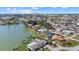 An aerial view shows waterfront homes with mature landscaping on a sunny day at 424 Shade Ter, Venice, FL 34293