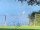 Lake view in the backyard, with a white ibis perched on the fence, adding to the scenic charm at 424 Shade Ter, Venice, FL 34293