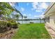 Well manicured backyard with lush green lawn and tranquil lake views at 424 Shade Ter, Venice, FL 34293
