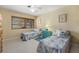 Bright bedroom with twin beds, coastal decor, and a window with blinds at 424 Shade Ter, Venice, FL 34293