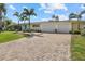 Inviting residence boasts a brick driveway, attached two car garage, and a well-maintained front lawn at 424 Shade Ter, Venice, FL 34293