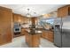 Bright kitchen with stainless steel appliances, island and granite counters at 424 Shade Ter, Venice, FL 34293