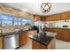 Bright kitchen boasting granite counters, stainless appliances, and center island at 424 Shade Ter, Venice, FL 34293