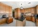 Spacious kitchen featuring an island, granite counters, and wooden cabinets at 424 Shade Ter, Venice, FL 34293