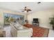 Living room features tile floors, a ceiling fan, a large window, and neutral paint at 424 Shade Ter, Venice, FL 34293