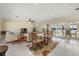 Spacious living room with natural light, tile floor, and sliding glass doors to the lanai at 424 Shade Ter, Venice, FL 34293
