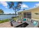 Relaxing patio with a comfortable sectional and tranquil lake view at 424 Shade Ter, Venice, FL 34293