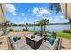 Spacious outdoor patio with a sectional, comfortable seating and scenic lake view at 424 Shade Ter, Venice, FL 34293