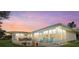 Outdoor living space with patio, comfortable seating, and beautiful sunset views at 424 Shade Ter, Venice, FL 34293