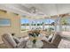 Bright sunroom with lake views, beamed ceiling, and seating area at 424 Shade Ter, Venice, FL 34293