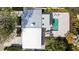 Aerial view of home showcasing its metal roof, patio, and pool with lounge chairs at 432 Palmetto Ct, Venice, FL 34285