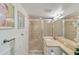 Well-lit bathroom boasts a shower, modern vanity, and neutral-toned tile flooring at 432 Palmetto Ct, Venice, FL 34285
