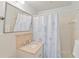 Cozy bathroom featuring a shower with a stylish jellyfish curtain and neutral-toned vanity at 432 Palmetto Ct, Venice, FL 34285