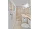 Well-lit bathroom boasts a shower, modern vanity, neutral-toned tile flooring and art at 432 Palmetto Ct, Venice, FL 34285