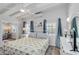 Inviting bedroom featuring bright white decor, beamed ceilings, and windows with natural light at 432 Palmetto Ct, Venice, FL 34285