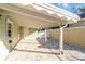A covered carport with brick flooring next to the house at 432 Palmetto Ct, Venice, FL 34285