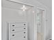 Inside the closet featuring a white dresser and doorway leading into another room at 432 Palmetto Ct, Venice, FL 34285
