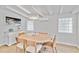 Bright dining room features a round wood table with seating for four and glass block windows at 432 Palmetto Ct, Venice, FL 34285