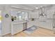 Bright open-concept kitchen with white cabinets, stainless steel appliances, and marble countertops overlooking outdoor pool at 432 Palmetto Ct, Venice, FL 34285