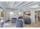 Bright room with light wood floors, views of kitchen, with access to the outside and door to the outside at 432 Palmetto Ct, Venice, FL 34285