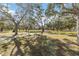 A tranquil park featuring walking paths, grassy areas, shaded by mature trees, and picnic tables at 432 Palmetto Ct, Venice, FL 34285