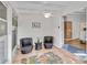 Enclosed patio area featuring neutral tile floors, ceiling fan, and wicker seating at 432 Palmetto Ct, Venice, FL 34285