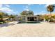 Backyard features a pool with a spacious brick patio and lush landscaping at 432 Palmetto Ct, Venice, FL 34285