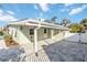 Exterior view of a one-story home with a carport and brick-paved backyard at 432 Palmetto Ct, Venice, FL 34285