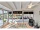 Bright sunroom featuring tile floor, ceiling fan, and multiple windows offering a pleasant view at 432 Palmetto Ct, Venice, FL 34285