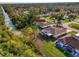 Beautiful aerial view of a well-maintained home with screened lanai and lush landscaping near a canal at 4332 Big Leaf St, North Port, FL 34286