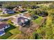 Aerial view of a property showcasing its screened lanai, spacious backyard, and surrounding neighborhood at 4332 Big Leaf St, North Port, FL 34286