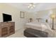 Cozy bedroom with carpet, ceiling fan, wicker dresser and furnishings at 4332 Big Leaf St, North Port, FL 34286