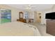 Bright bedroom with natural light, ceiling fan, carpet, and views of the yard at 4332 Big Leaf St, North Port, FL 34286