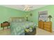 Green bedroom with queen bed, carpet, ceiling fan and natural light at 4332 Big Leaf St, North Port, FL 34286