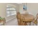 A dining room featuring a wooden table and chairs with warm, neutral walls at 4332 Big Leaf St, North Port, FL 34286