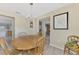 Traditional dining room with wood table, chandelier, and view into other rooms at 4332 Big Leaf St, North Port, FL 34286