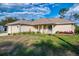 Charming single-story home with a well-manicured lawn and inviting front porch at 4332 Big Leaf St, North Port, FL 34286