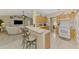Open-concept kitchen with breakfast bar offers seamless transition to the living area at 4332 Big Leaf St, North Port, FL 34286
