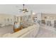 Bright, open-concept living space showcasing a large sectional sofa and access to the kitchen at 4332 Big Leaf St, North Port, FL 34286