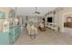 Open-concept living room with a large sectional, modern décor, and wood-look flooring at 4332 Big Leaf St, North Port, FL 34286
