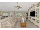 Well-lit living room with a large sectional sofa and entertainment center at 4332 Big Leaf St, North Port, FL 34286