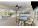 Enclosed lanai with several tables/chairs perfect for entertaining, offers views of the pool and surrounding foliage at 4332 Big Leaf St, North Port, FL 34286