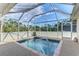 A screened-in pool/spa features easy access with a handrail and offers gorgeous views of the landscape at 4332 Big Leaf St, North Port, FL 34286